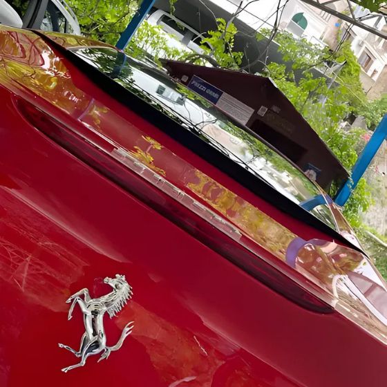 Close-up of a red Ferrari parked safely inside the guarded facility in Positano.